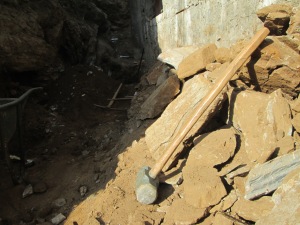 Rebuilding the retaining wall means digging a new trench, which means breaking some rocks buried in the ground!
